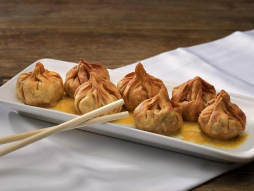 a plate of food on a table with chopsticks at H10 Metropolitan 4* Sup in Barcelona