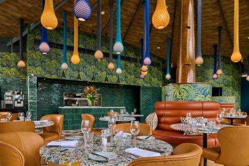 a dining room with tables and chairs and lights at Hotel du Vin Exeter in Exeter