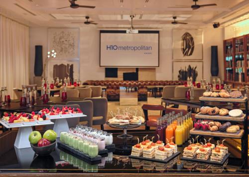 a lobby with a table filled with food and a presentation at H10 Metropolitan 4* Sup in Barcelona