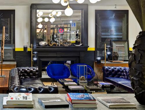 a living room with couches and a fireplace at H10 Metropolitan 4* Sup in Barcelona