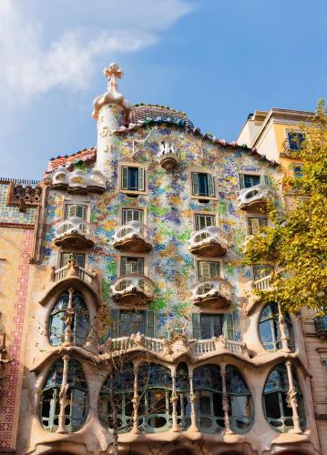 a building covered in graffiti with a cross on top at H10 Metropolitan 4* Sup in Barcelona