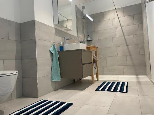 a bathroom with a sink and a toilet at Lokstadt in Winterthur