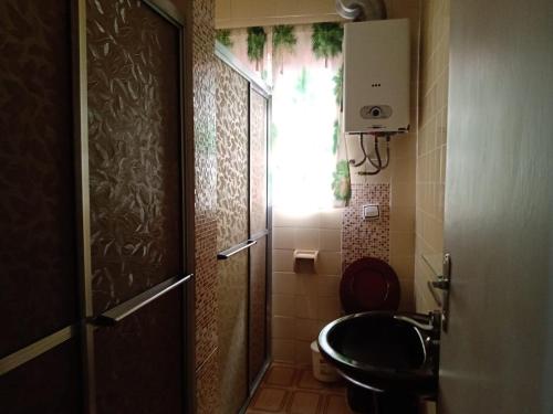 a bathroom with a toilet and a sink and a window at casa donna zilda in Extrema