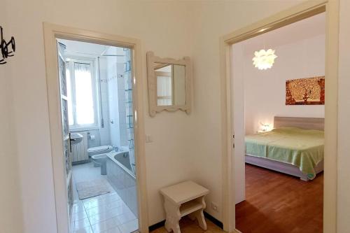 a bedroom with a bed and a bathroom with a mirror at a mio agio apartment in Lecco