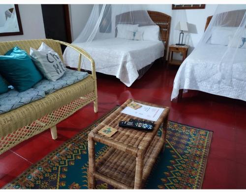 a living room with two beds and a coffee table at Ltu Garden in Negril