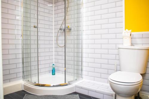 a bathroom with a shower and a toilet at Central Eden Retreat (private room) in Liverpool