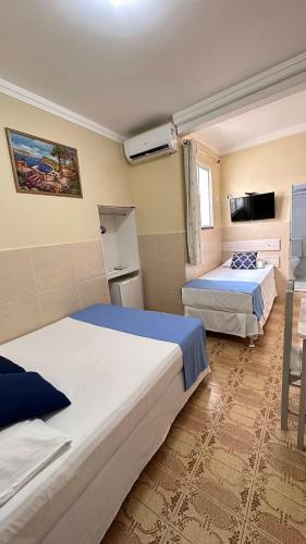 Ένα ή περισσότερα κρεβάτια σε δωμάτιο στο Pousada São Luiz