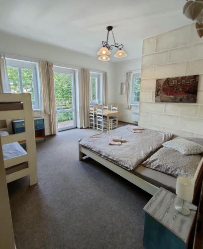 a bedroom with a bed and a table and chairs at Penzion Severka in Teplice nad Metují