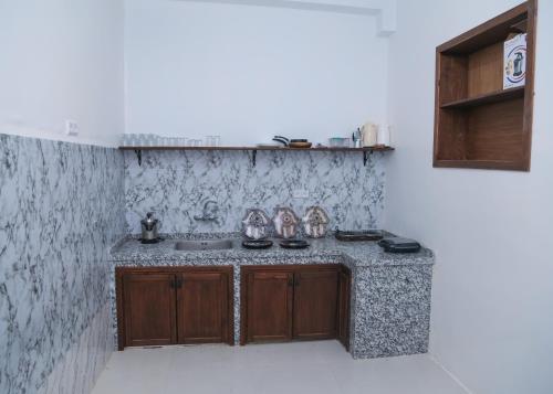 a kitchen with a sink and shoes on a counter at CASA BLUE PEARL in Chefchaouen