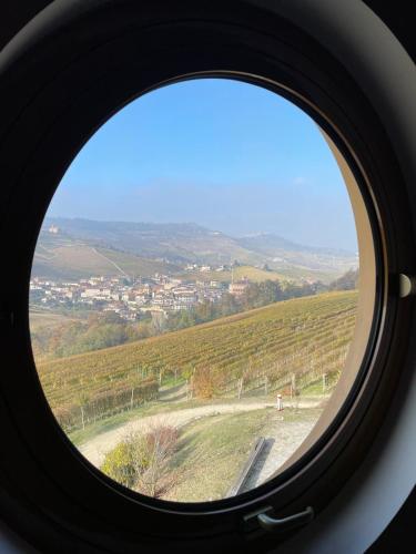 a round window looking out at a vineyard at Cascina Boschetti in Barolo