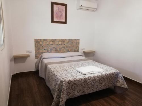 - une petite chambre avec un lit et une couverture dans l'établissement CASA ENCINA, à Tolox