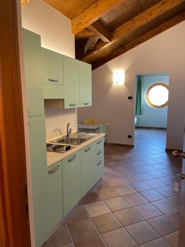 a kitchen with white cabinets and a table in a room at Cascina Boschetti in Barolo