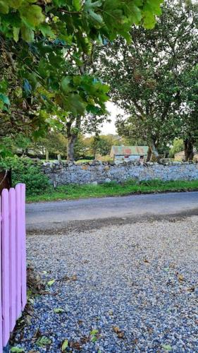 a pink fence on the side of a road at Meadow Lane in Sligo