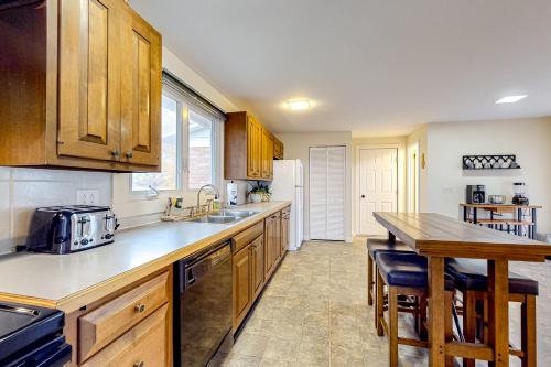 a kitchen with wooden cabinets and a wooden counter top at Falling Leaf Hideaway in Canandaigua