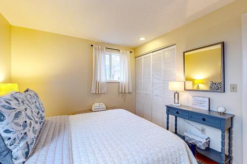 a bedroom with a bed and a mirror and a window at Falling Leaf Hideaway in Canandaigua