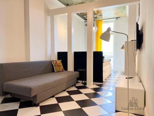 a living room with a couch and a checkered floor at Aesthetic apartment Krakow-Center in Krakow