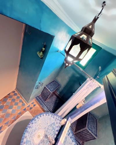 an overhead view of a chandelier above a table at Riad Al Nour in Marrakech