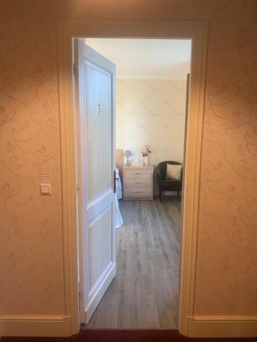 an open door into a room with a bedroom at Le Pontet in Miramont-de-Guyenne
