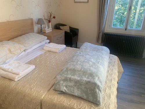 a bedroom with two beds with towels on them at Le Pontet in Miramont-de-Guyenne