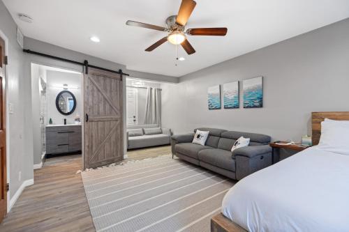 a bedroom with a bed and a ceiling fan at On the Boardwalk in Long Beach