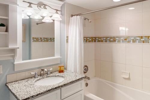 a bathroom with a sink and a tub and a shower at Lasata 3204 in Destin