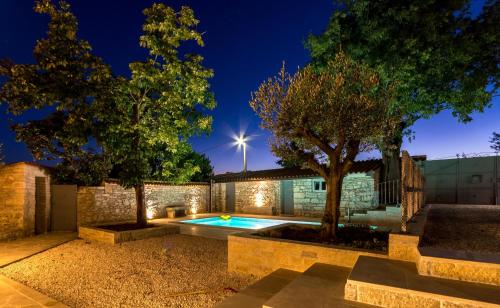a house with a swimming pool at night at Heritage Villa Cranzetti in Svetvinčenat