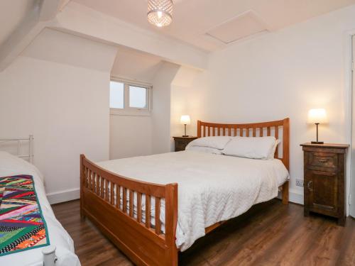 a bedroom with a wooden bed and two night stands at Sunnycote in Carnforth