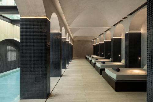 a bathroom with a row of sinks and a swimming pool at MS Collection Aveiro - Palacete Valdemouro in Aveiro