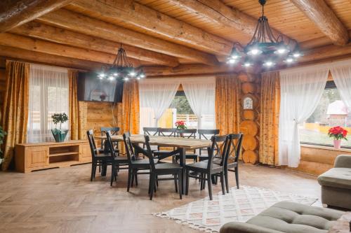 a dining room with a wooden table and chairs at Chalet Ciocanesti in Ciocăneşti