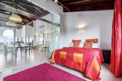 a bedroom with a bed and a dining room at Fine 3 BR Oceanview Penthouse in Prime Location - La Perla Sky in Cupecoy