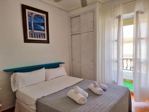 a bedroom with two towels on a bed at Sunflower Playa Lisa in Santa Pola
