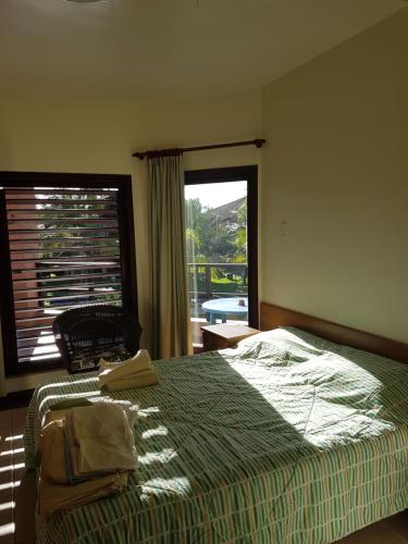 a bedroom with a bed and a large window at Cumbuco Dream Beach Luxury beach apartments in Caucaia