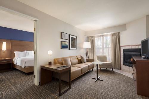a hotel room with a couch and a bed at Residence Inn San Jose South/Morgan Hill in Morgan Hill