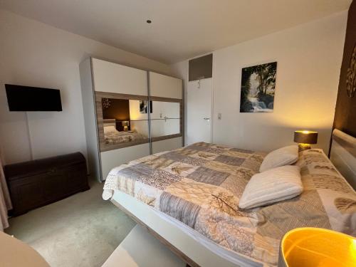 ein Schlafzimmer mit einem großen Bett und einem Fernseher in der Unterkunft Ferienwohnung Mogwitz mit Schwimmbad und Saunanutzung in Bad Harzburg