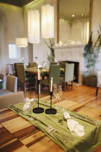 a table with two candles and wine glasses on it at Estancia La Paz Hotel in Ascochinga