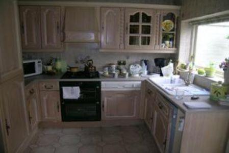 a kitchen with white cabinets and a black stove top oven at Luxury Double Room near London Seven Kings Train Station in Seven Kings