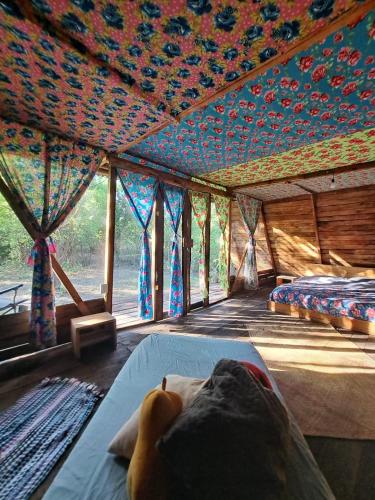 a person laying on a bed in a room at Planta Farm - Jungle Stay in Santa Maria Huatulco
