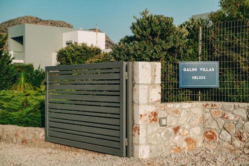 a gate in front of a fence with a sign at Helios a modern large villa with private pool set in a quiet location in Stavros