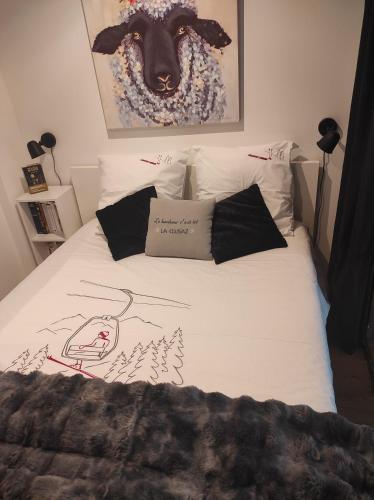 un letto con un disegno di una pecora sopra di Le Week-End 3 étoiles, plein centre ville a La Clusaz