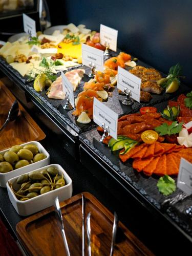 a buffet with many different types of food on display at Queen's Court Hotel & Residence in Budapest