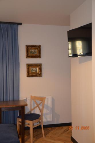 a room with a wooden table and a chair and a table and a table at Arte Gdańsk in Gdańsk