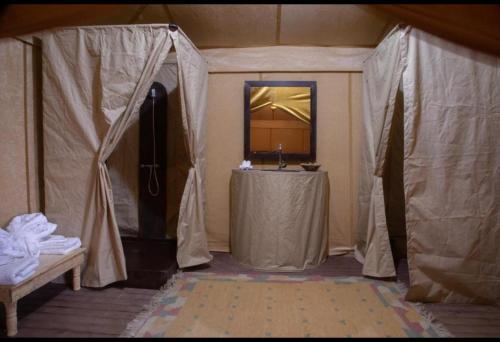 a tent with a table in a room at FABIN ATLAS MARRAKECH TOURS in Marrakech