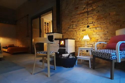 a living room with a couch and a brick wall at Depo Loco ( Banícke depo) in Špania Dolina