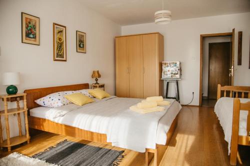 a bedroom with a large bed with towels on it at Soba Gloria in Slavonski Brod