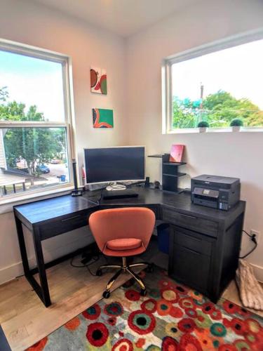 an office with a desk and a red chair at East Austintacious - artsy, walkable 4BR 4BA in Austin