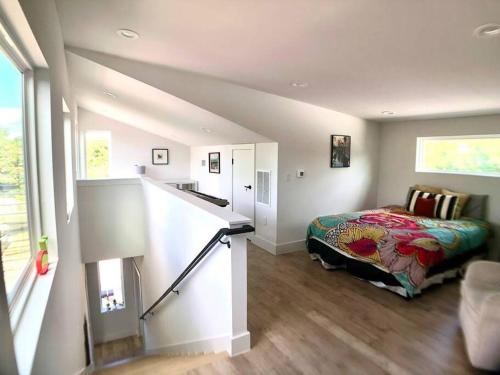 a bedroom with a bed and a staircase in a room at East Austintacious - artsy, walkable 4BR 4BA in Austin