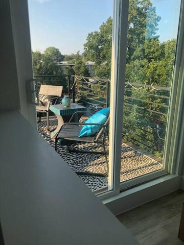a view of a balcony with a chair and a table at East Austintacious - artsy, walkable 4BR 4BA in Austin