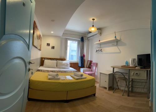 a bedroom with a bed and a desk and a table at Rodin Hostel in Istanbul
