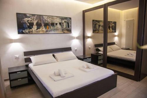 a bedroom with a large bed and a mirror at ROME Chic and Elegant Apartment near METRO Station in Rome