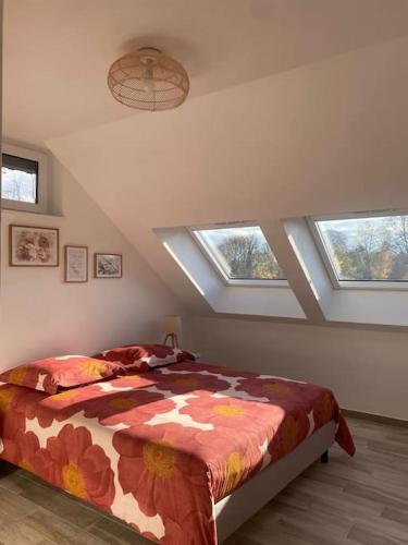 um quarto com uma cama num quarto com clarabóias em Appartement dans une grange rénovée em Estrasburgo